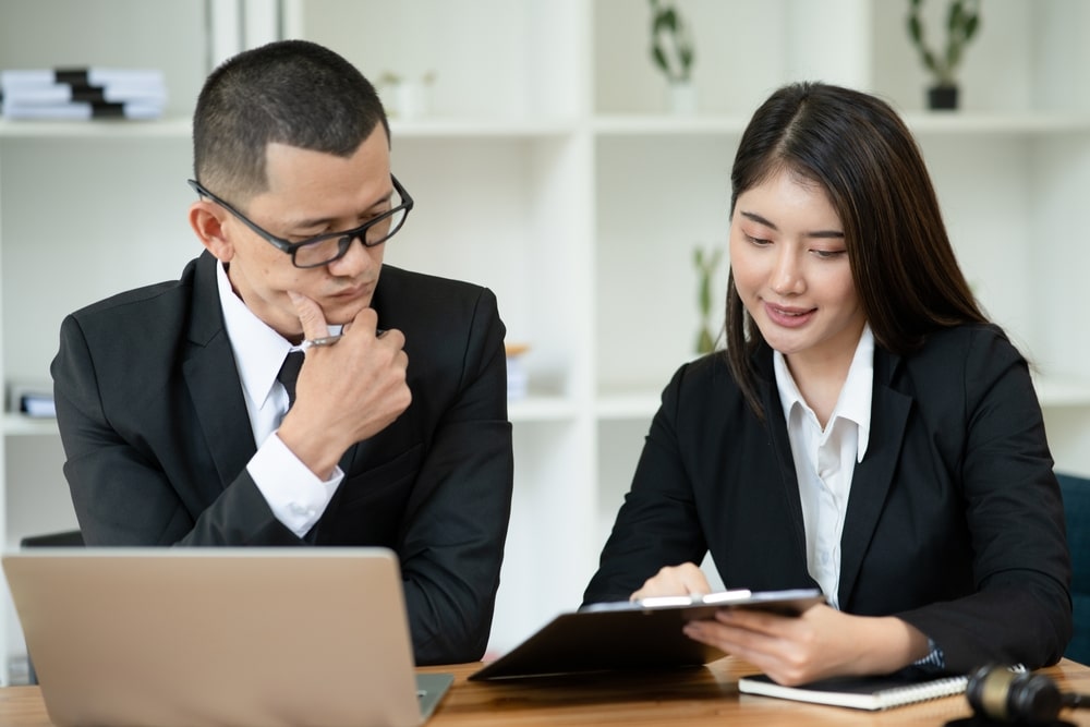 Photo of two people sitting at the desk