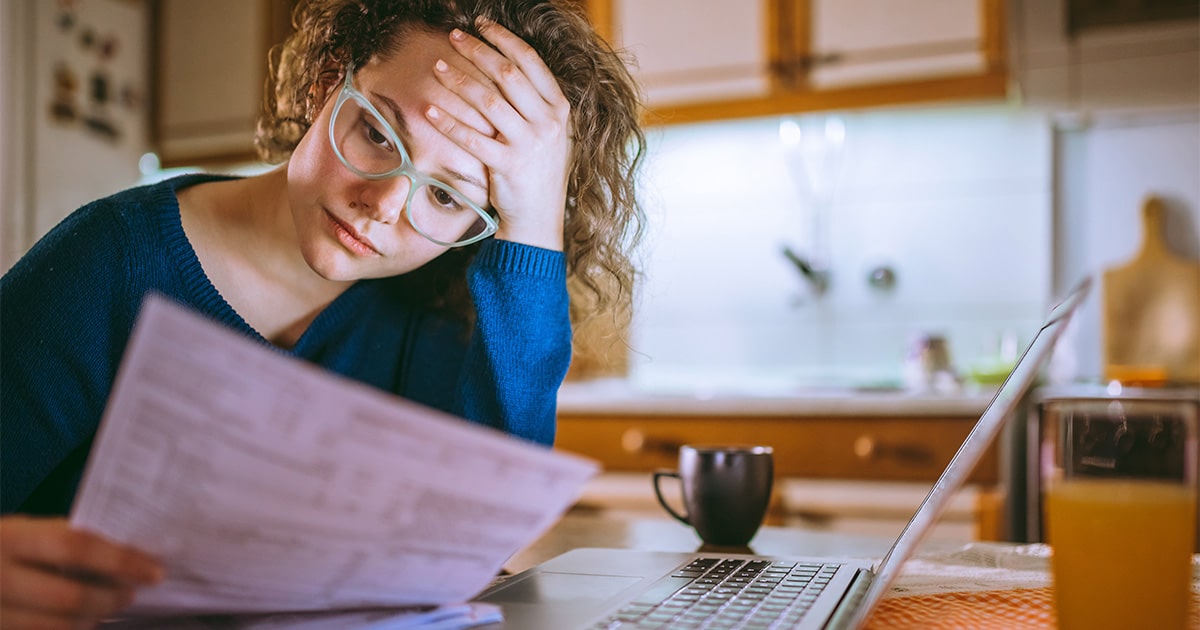 Woman Sitting at a Table Reviewing Documents
