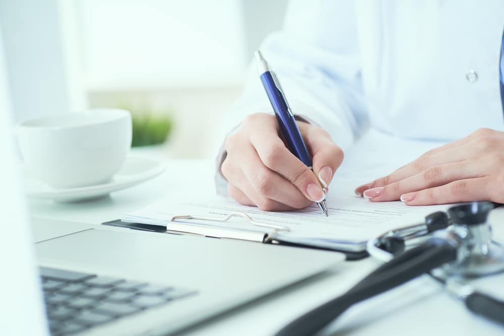 Photo of a person writing a paper