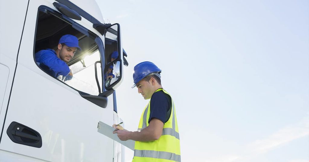 Person with a Helmet Talking to Truck Driver Photo of Truck
