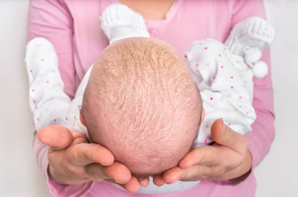 Newborn Baby Nurse In A Pink Shirt Holding A Newborn Baby