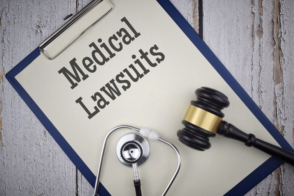 Medical Lawsuit Title Written On A Paper With Judges Hammer And Stethoscope On Top