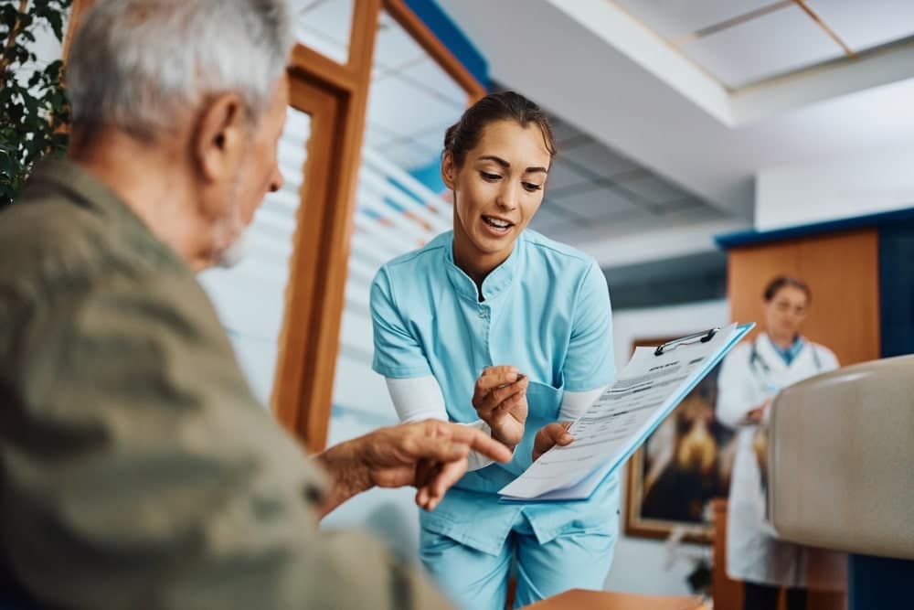 Medical Nurse Showing Statistics To A Patient