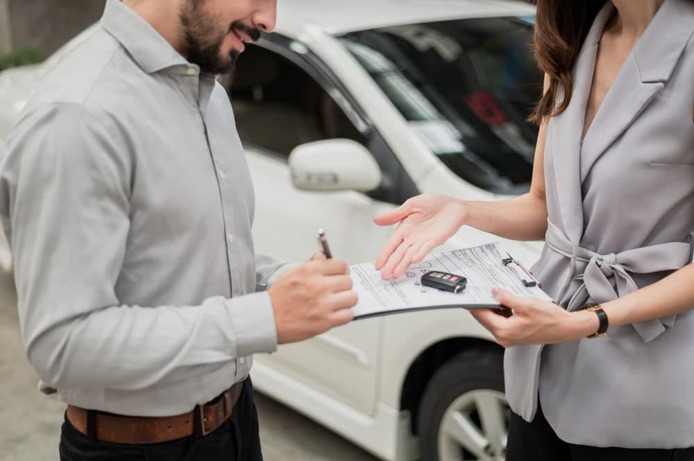 a person standing next to a car