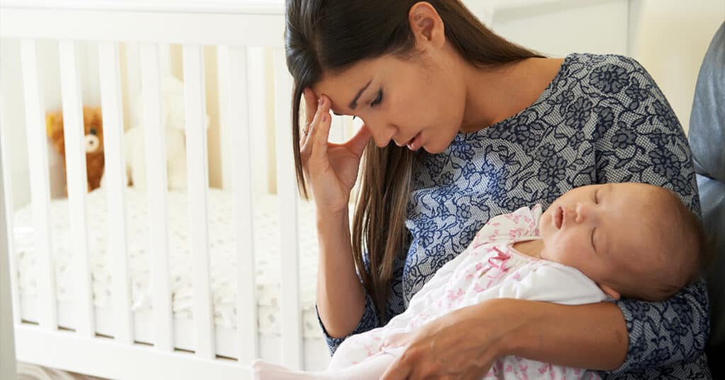 a woman holding a baby