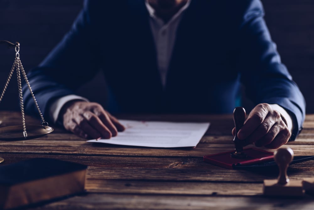 Photo of a person sitting at the wooden desk