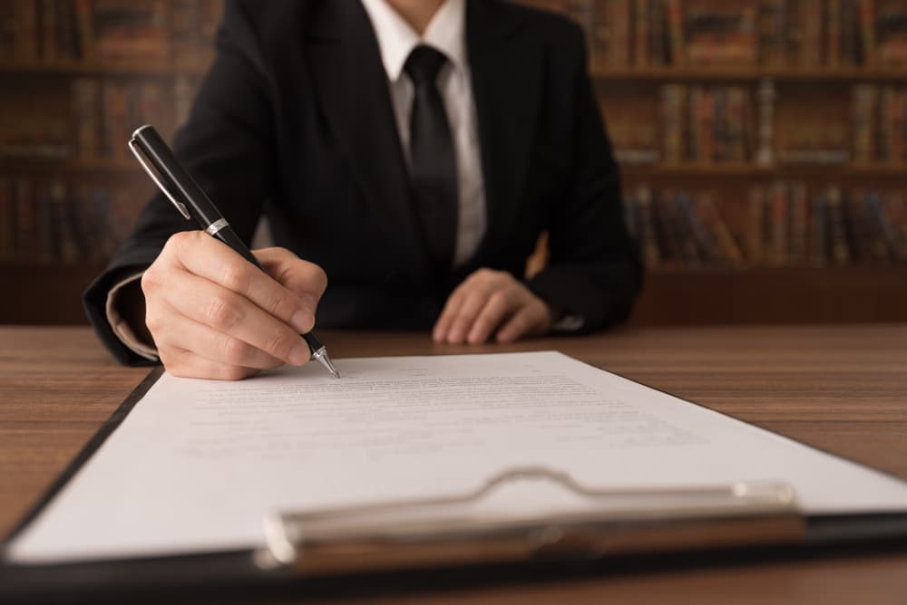 A man writing a paper