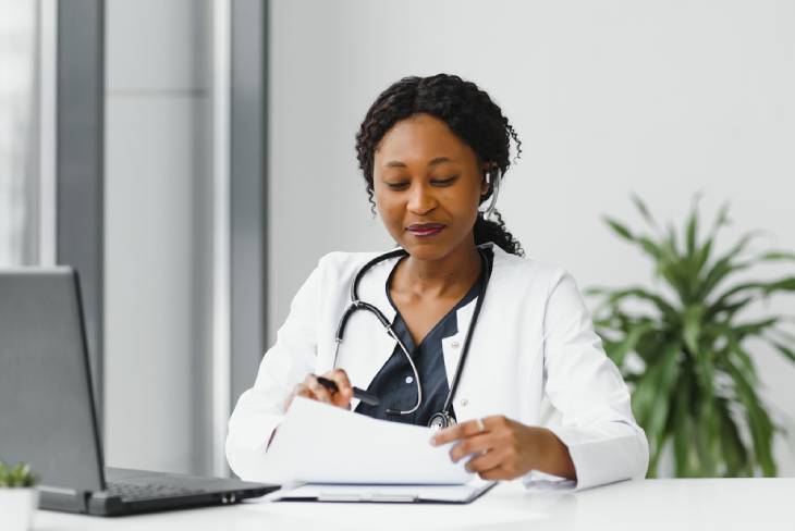 Photo of a doctor filling papers at the desk