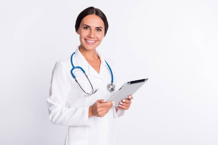 Photo of the person with tablet in hands standing