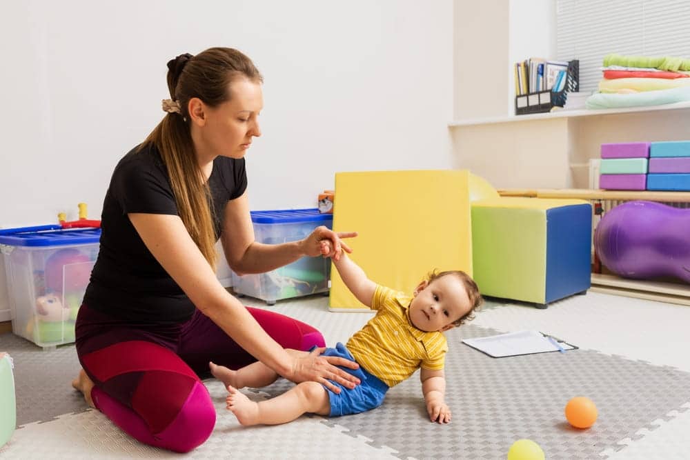 Woman Helping An Infant